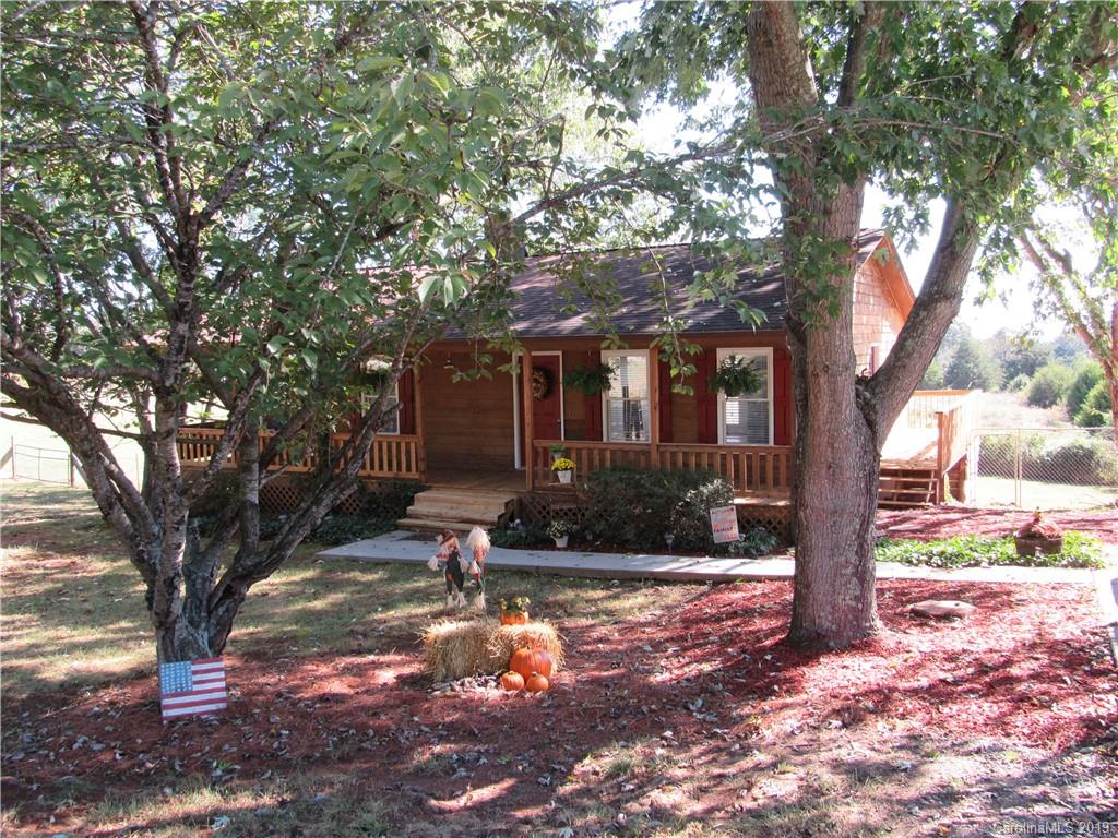 1226 Howards Creek Mill Road Vale, NC 28168 - Photo 22 of 22 a tree in front of a white house