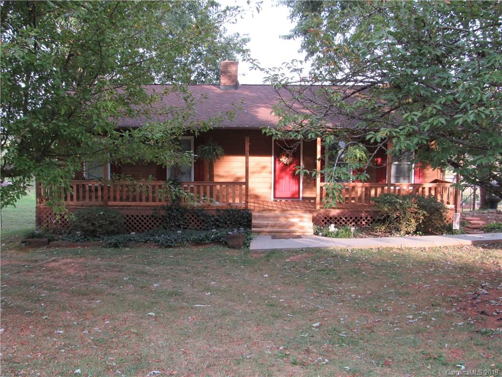 1226 Howards Creek Mill Road Vale, NC 28168 - Photo 4 of 22 a view of a house with a small yard and a large tree