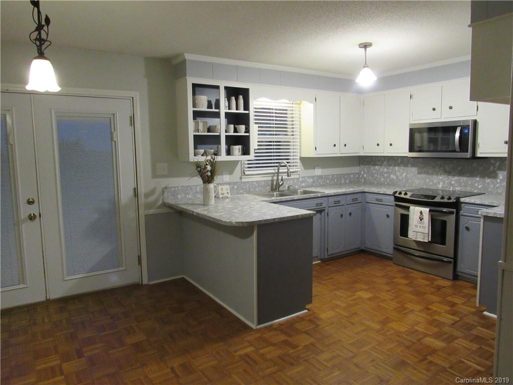 1226 Howards Creek Mill Road Vale, NC 28168 - Photo 6 of 22 a kitchen with stainless steel appliances granite countertop a sink stove and refrigerator