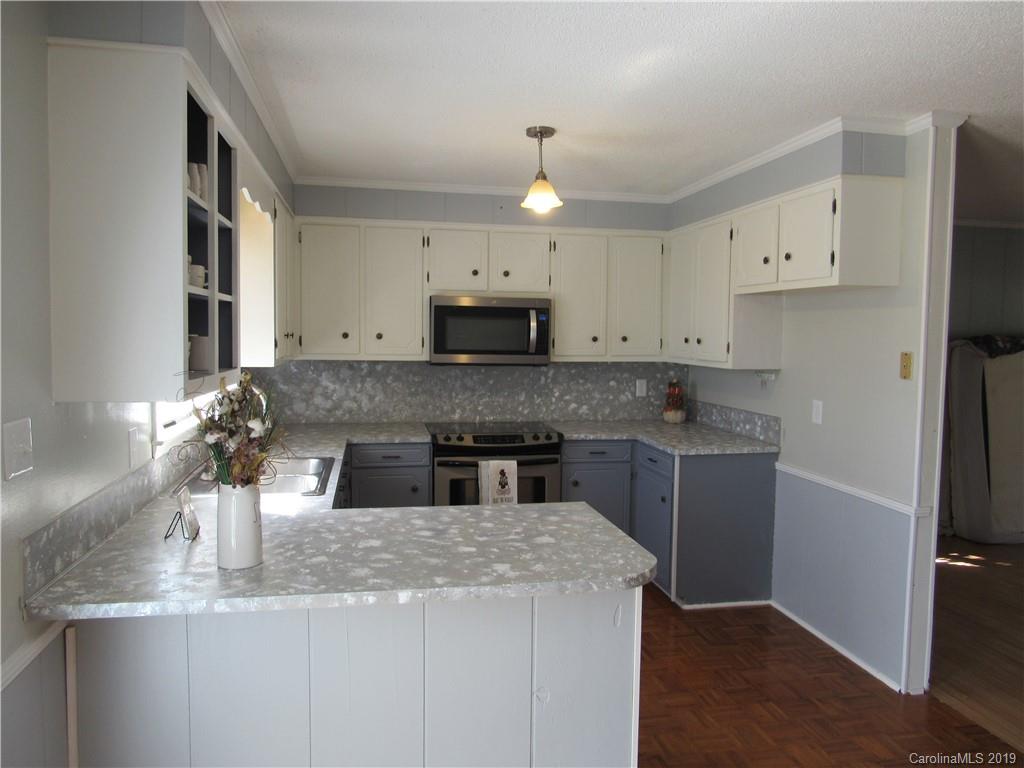 1226 Howards Creek Mill Road Vale, NC 28168 - Photo 10 of 22 a kitchen with stainless steel appliances granite countertop a sink and a refrigerator