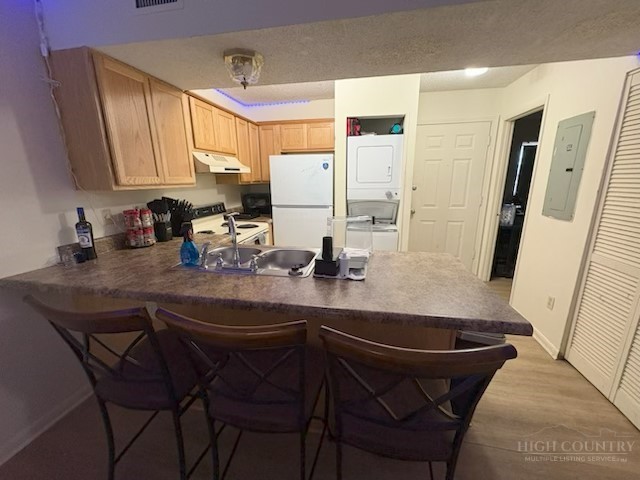 229 East King Street, Unit 31 Boone, NC 28607 - Photo 12 of 26 a kitchen with stainless steel appliances a sink and a refrigerator
