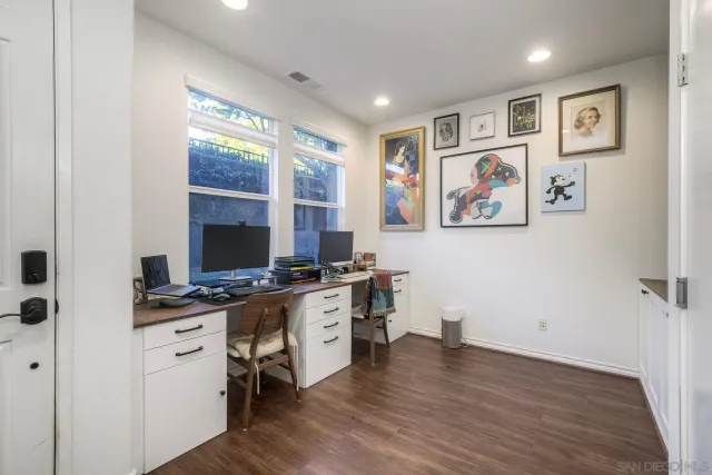 a view of a workspace with furniture and window