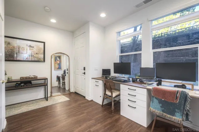 a workspace with furniture window and wooden floor