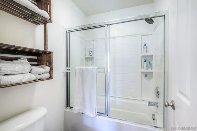 a bathroom with a shower and a toilet