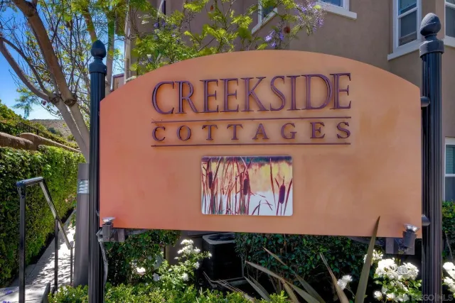 a street sign on a wall next to a building