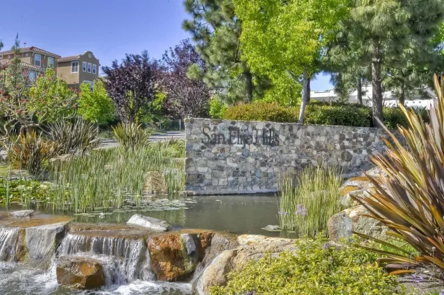 a view of a fountain in front of a house