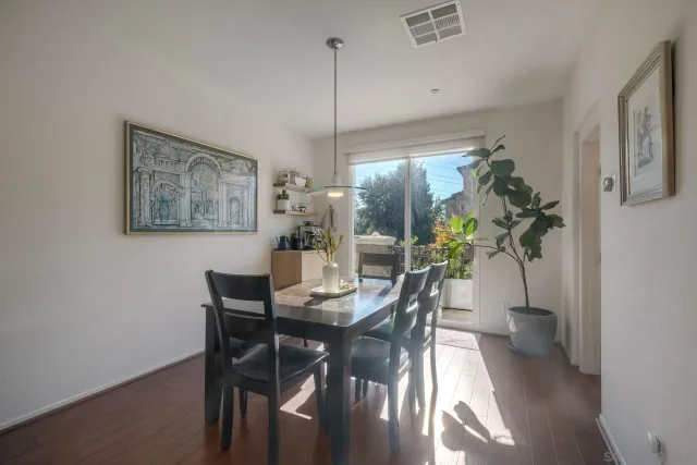 a dining room with furniture and potted plant