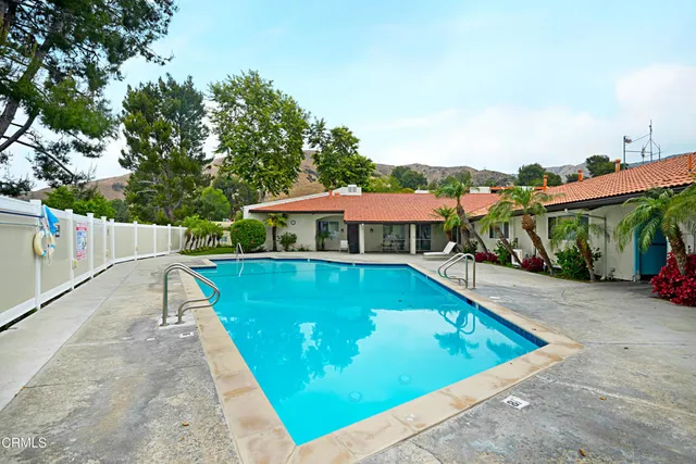 a view of a swimming pool with a patio