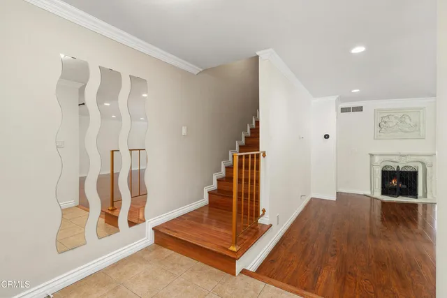 a view of a livingroom with wooden floor and a fireplace