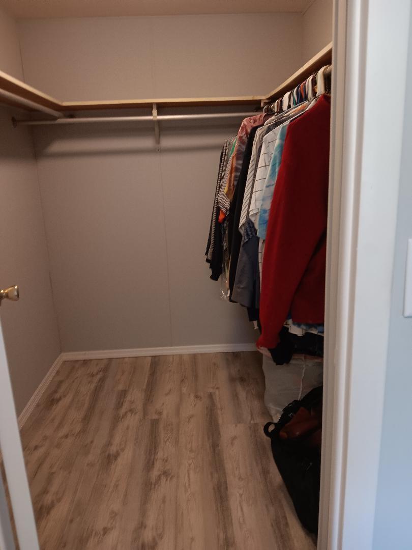 6985 Southeast Amendment Street Hobe Sound, FL 33455 - Photo 13 of 27 a view of walk in closet with clothes and shoes