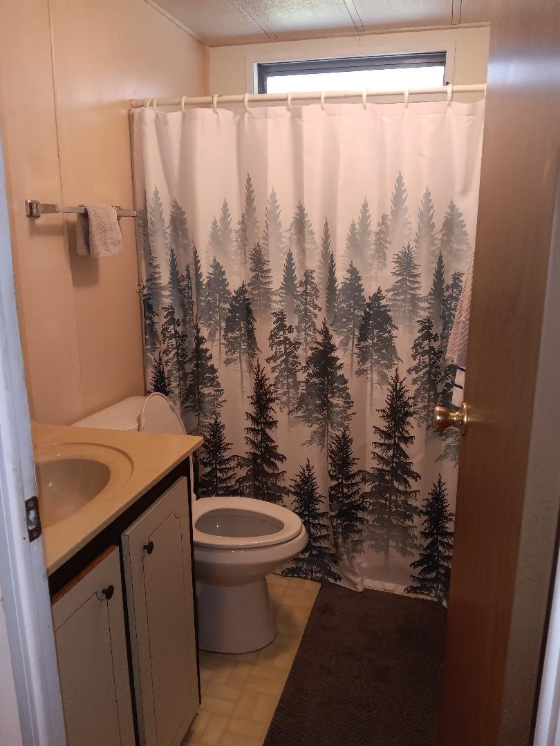 6985 Southeast Amendment Street Hobe Sound, FL 33455 - Photo 16 of 27 a bathroom with a sink toilet and shower