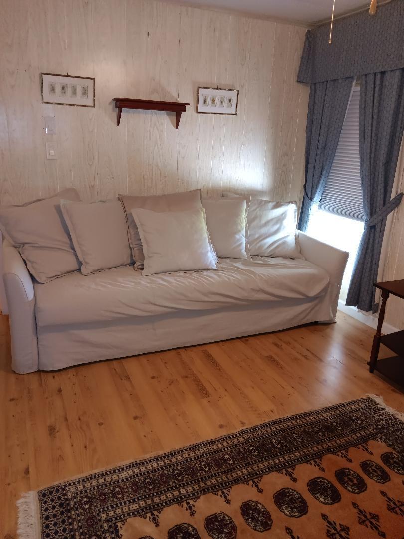 6985 Southeast Amendment Street Hobe Sound, FL 33455 - Photo 17 of 27 a living room with a couch