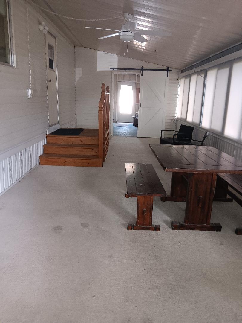 6985 Southeast Amendment Street Hobe Sound, FL 33455 - Photo 19 of 27 a room with furniture and a projector screen