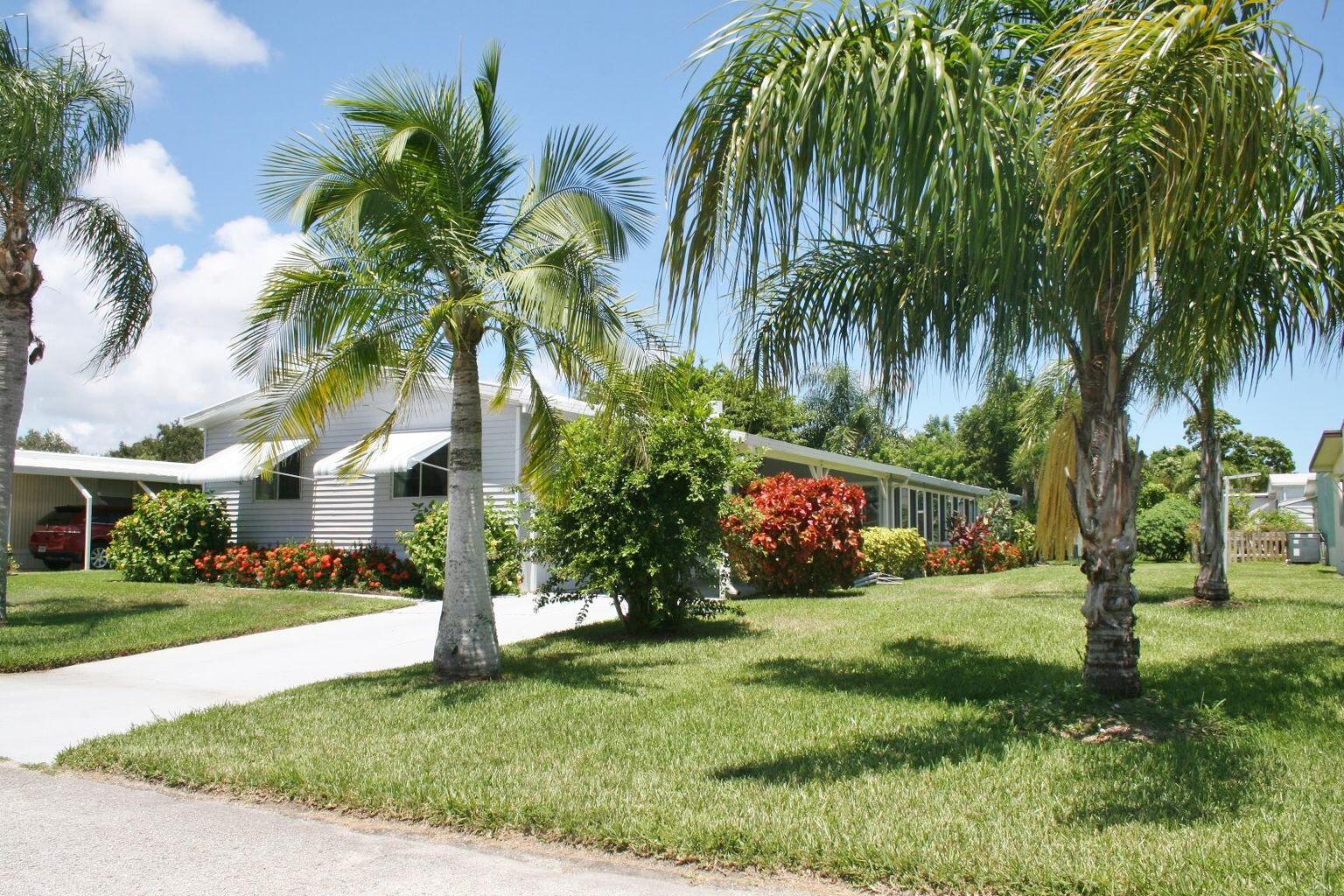 6985 Southeast Amendment Street Hobe Sound, FL 33455 - Photo 2 of 27 a view of a park with palm trees