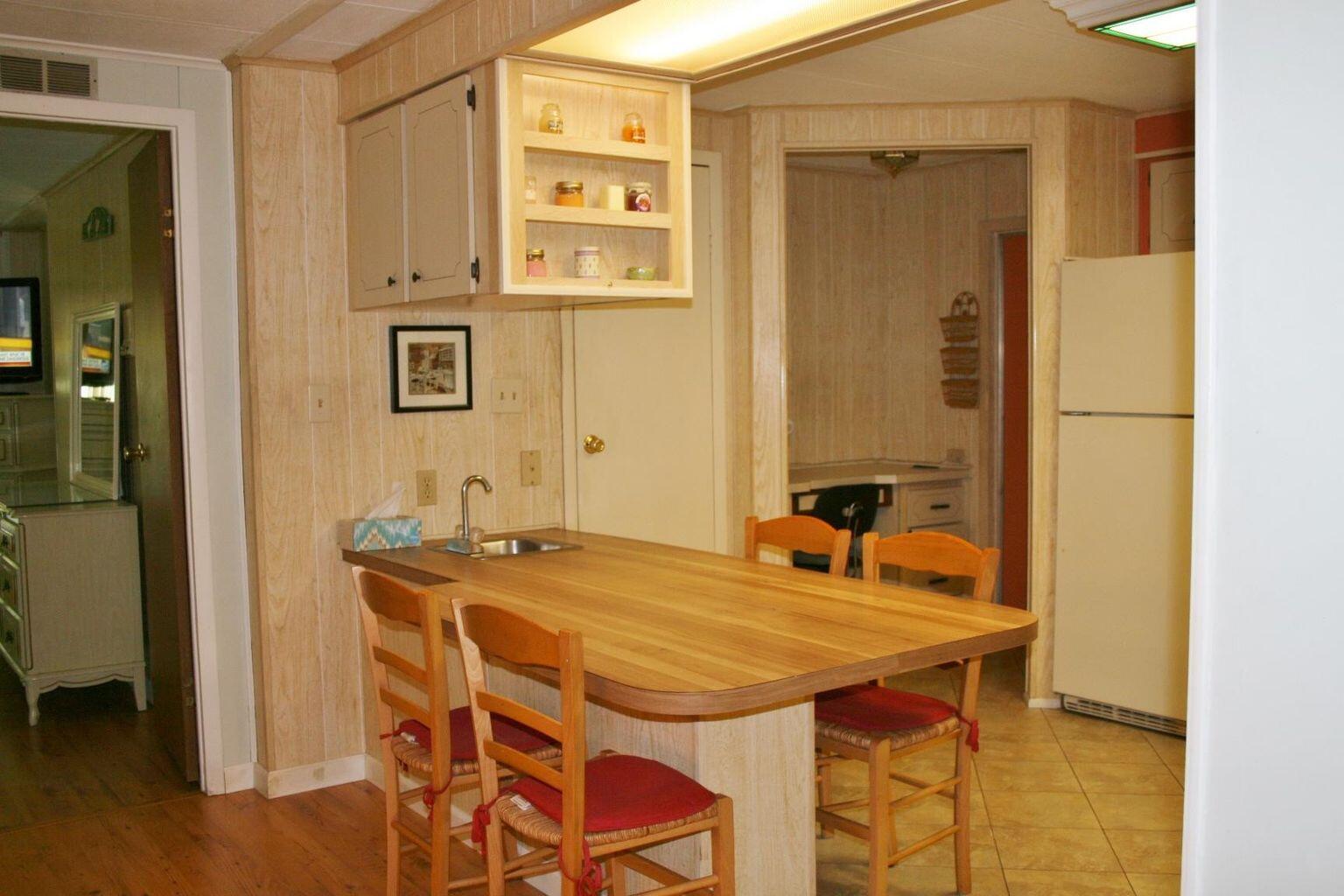 6985 Southeast Amendment Street Hobe Sound, FL 33455 - Photo 3 of 27 a dining room with a table and chairs
