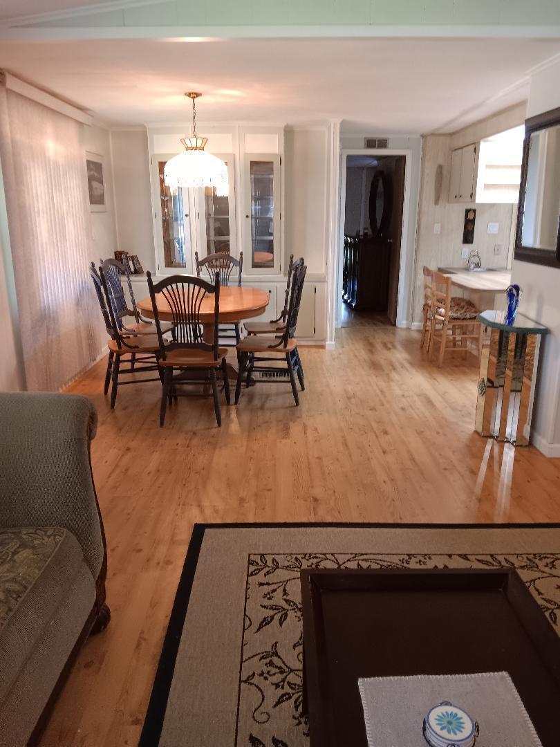 6985 Southeast Amendment Street Hobe Sound, FL 33455 - Photo 8 of 27 a view of a dining room with furniture and a chandelier