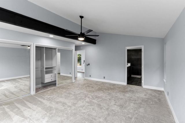 a bathroom with a double vanity sink large mirror and bathtub
