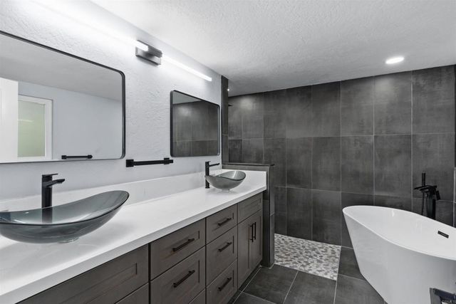 a bathroom with double vanity sink and a mirror