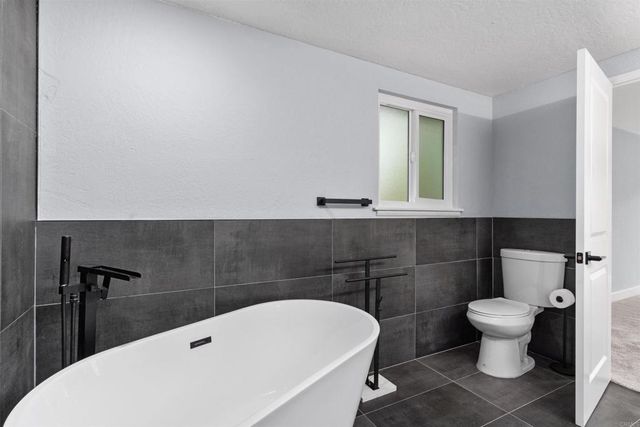 a living room with furniture a chandelier and a window