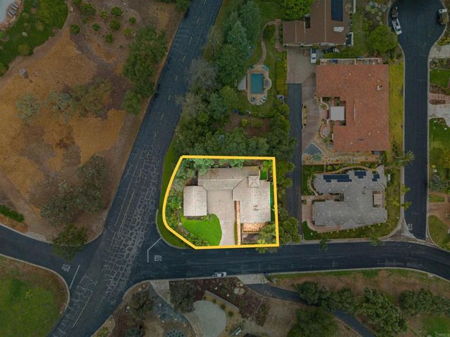 a view of a house with backyard and a patio