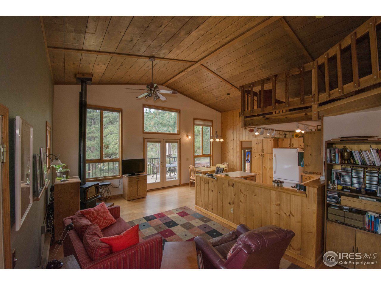 1473 Streamside Drive Drake, CO 80515 - Photo 11 of 24 a living room with furniture a fireplace and large windows