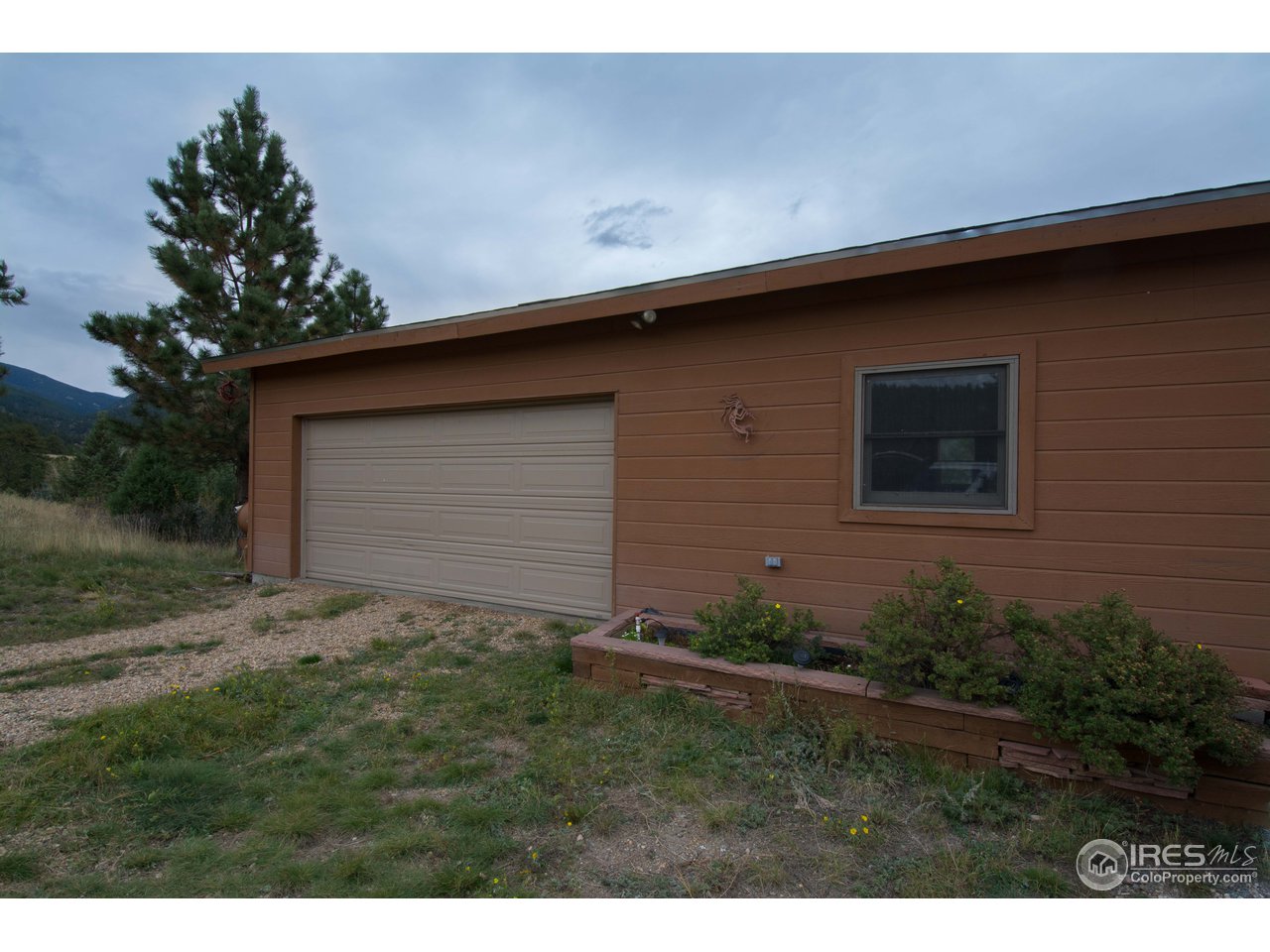 1473 Streamside Drive Drake, CO 80515 - Photo 22 of 24 a backyard of a house with lots of green space