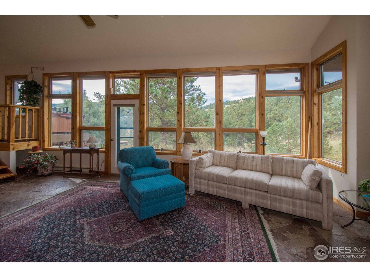 1473 Streamside Drive Drake, CO 80515 - Photo 4 of 24 a living room with furniture and a floor to ceiling window