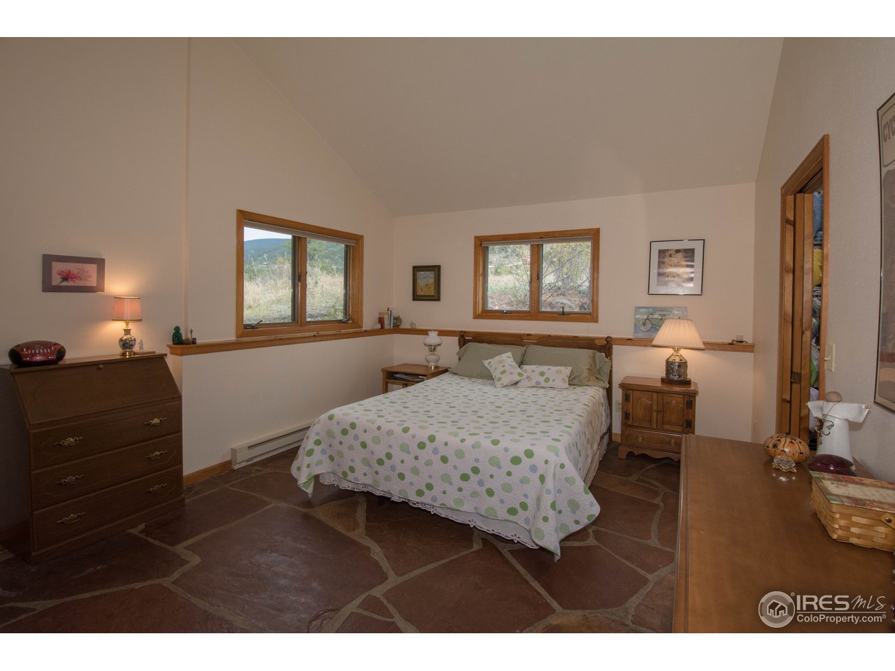 1473 Streamside Drive Drake, CO 80515 - Photo 5 of 24 a bedroom with a bed and wooden floor