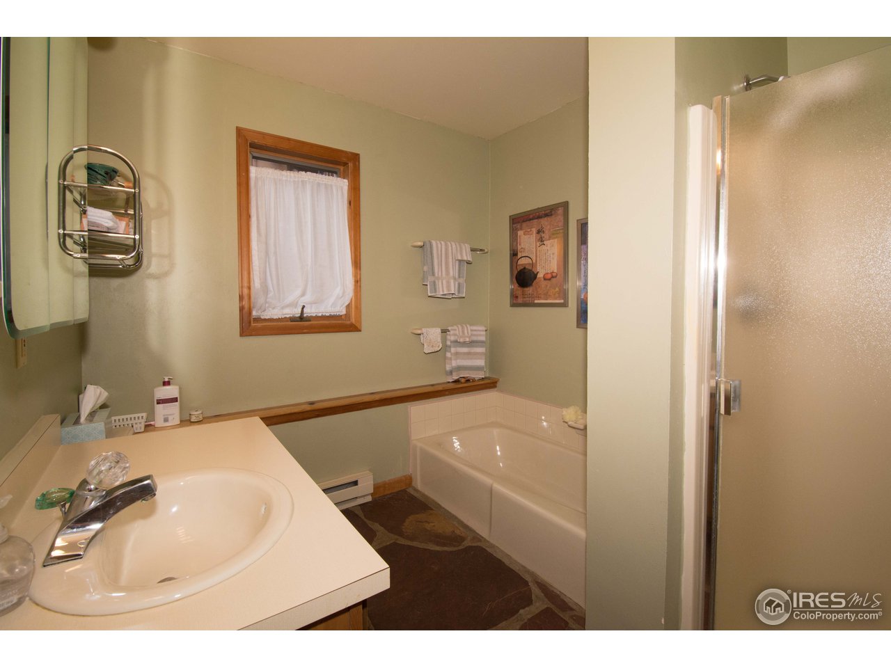 1473 Streamside Drive Drake, CO 80515 - Photo 7 of 24 a bathroom with a tub sink and mirror