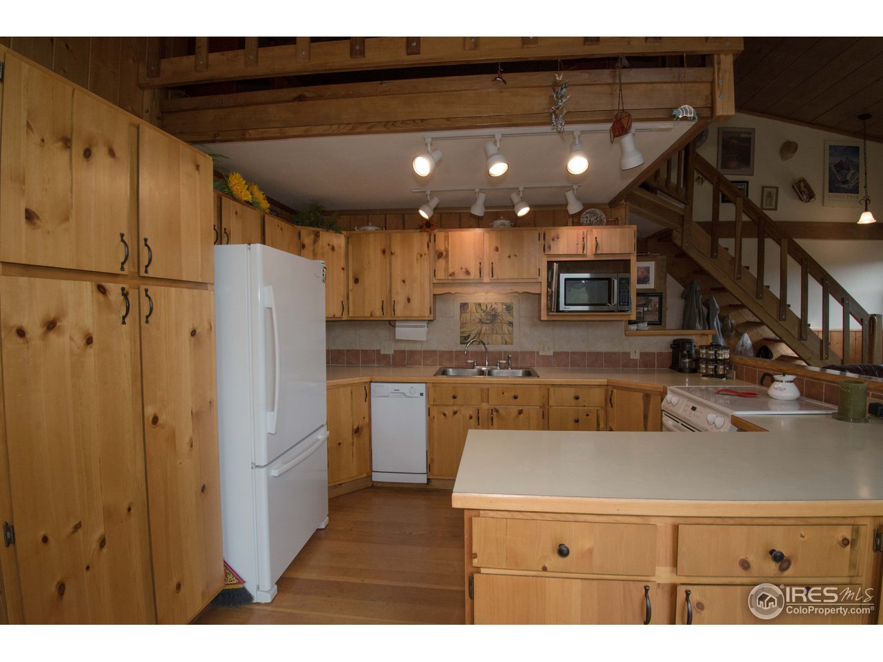 1473 Streamside Drive Drake, CO 80515 - Photo 8 of 24 a kitchen with stainless steel appliances granite countertop a refrigerator a sink and a stove