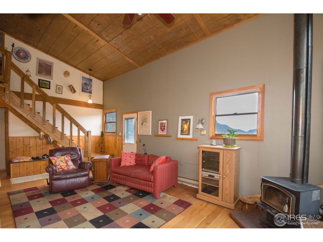 1473 Streamside Drive Drake, CO 80515 - Photo 10 of 24 a living room with furniture a rug and a painting on the wall