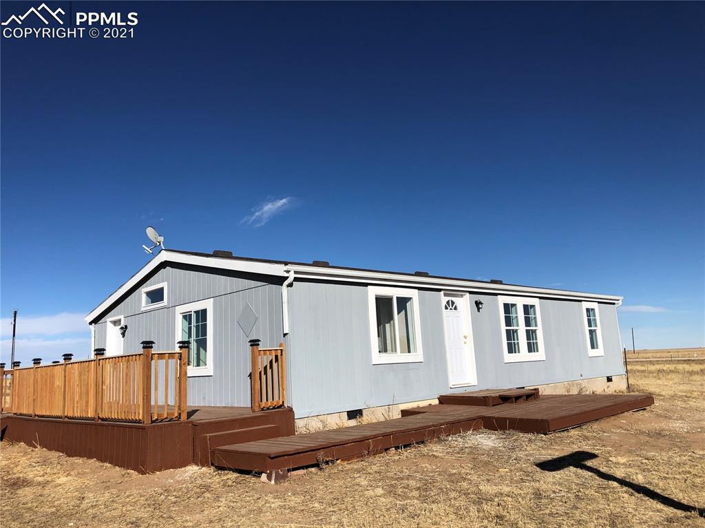 34755 Big Springs Road Yoder, CO 80864 - Photo 1 of 29 a front view of a house with a yard