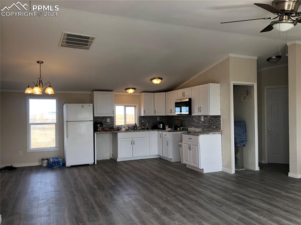 34755 Big Springs Road Yoder, CO 80864 - Photo 11 of 29 a kitchen with refrigerator and microwave