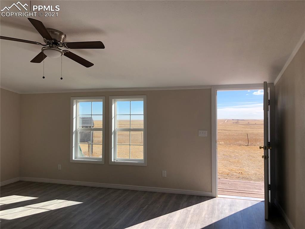 34755 Big Springs Road Yoder, CO 80864 - Photo 13 of 29 wooden floor in an empty room with a window