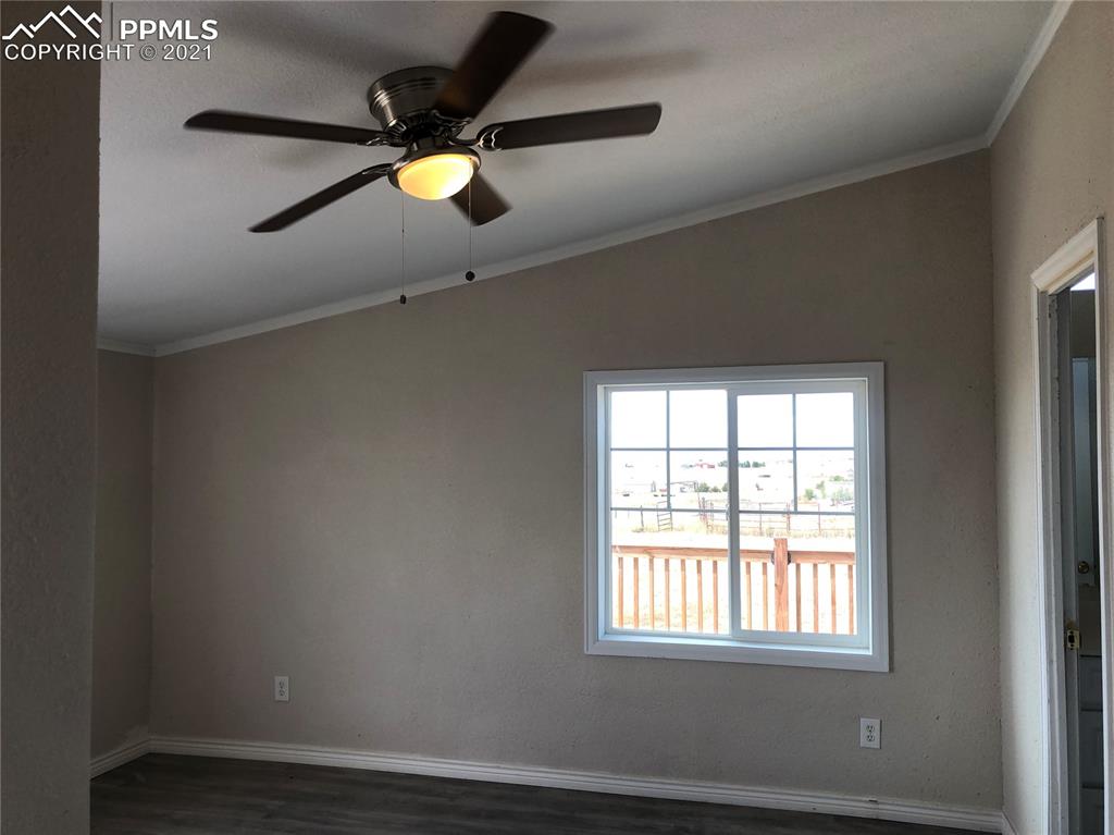 34755 Big Springs Road Yoder, CO 80864 - Photo 14 of 29 an empty room with wooden floor and windows