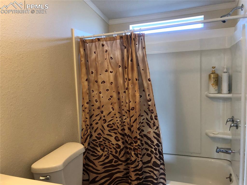 34755 Big Springs Road Yoder, CO 80864 - Photo 21 of 29 a bathroom with a shower curtain and a toilet