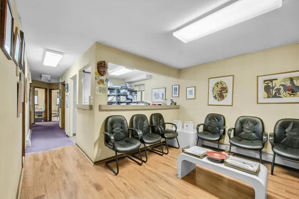 a work room with furniture and wooden floor