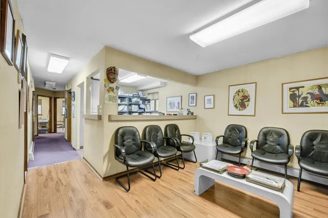 a work room with furniture and wooden floor