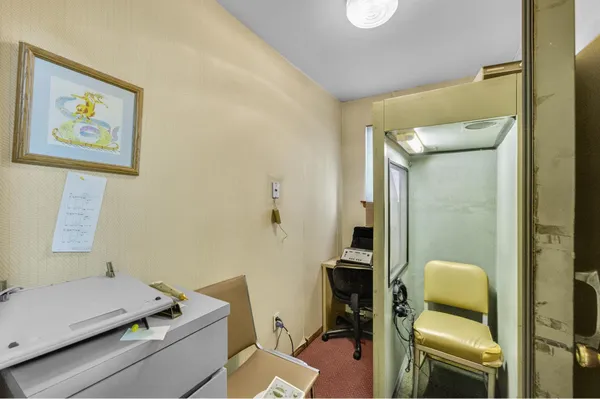 a view of a workspace with furniture and a living room