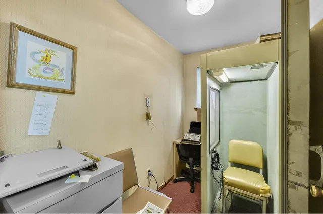 a view of a workspace with furniture and a living room