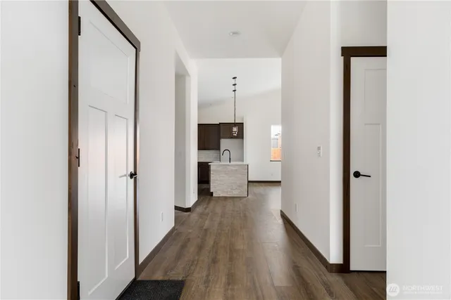 a view of a hallway with wooden floor