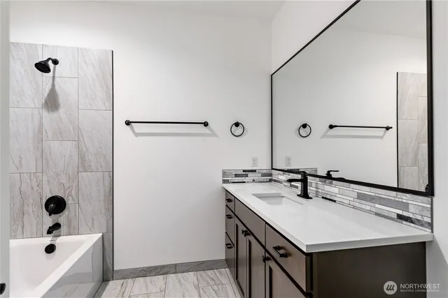 a bathroom with a sink a mirror and shower