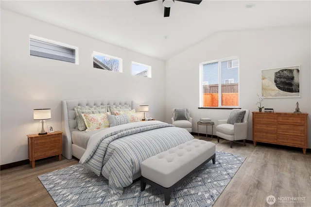 a bedroom with bed couch and window