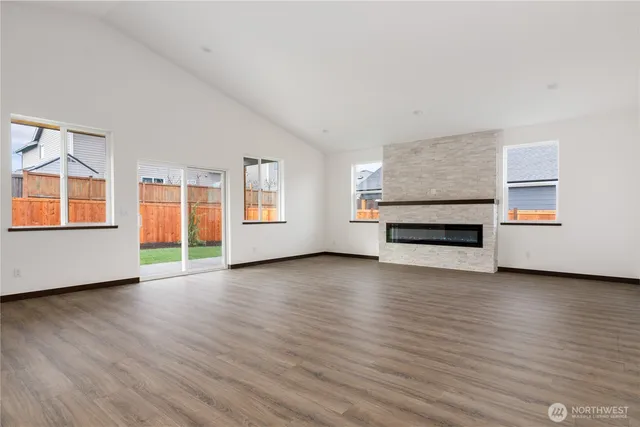 a view of empty room with wooden floor and window