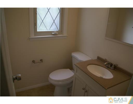 26 Gramercy Road Old Bridge, NJ 08857 - Photo 11 of 14 a bathroom with a toilet a sink and mirror