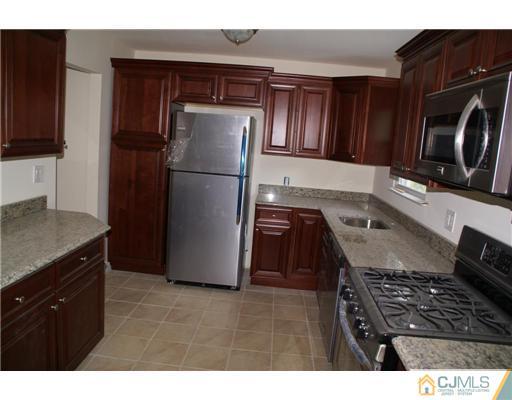 26 Gramercy Road Old Bridge, NJ 08857 - Photo 4 of 14 a kitchen with a refrigerator and a sink