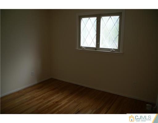 26 Gramercy Road Old Bridge, NJ 08857 - Photo 7 of 14 a view of a big room with wooden floor and windows