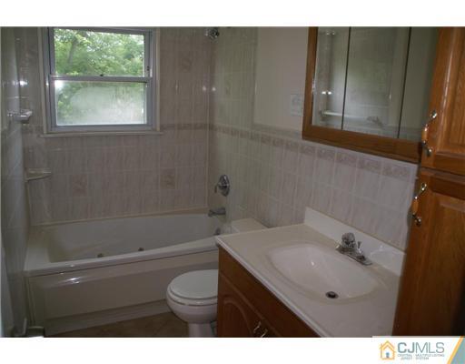 26 Gramercy Road Old Bridge, NJ 08857 - Photo 10 of 14 a bathroom with a sink a toilet and shower