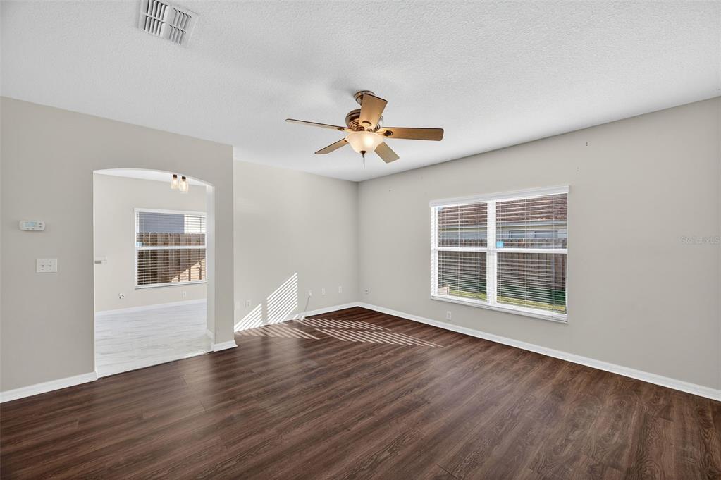 28632 Seashell Court Wesley Chapel, FL 33545 - Photo 13 of 60 a view of an empty room with a window and wooden floor