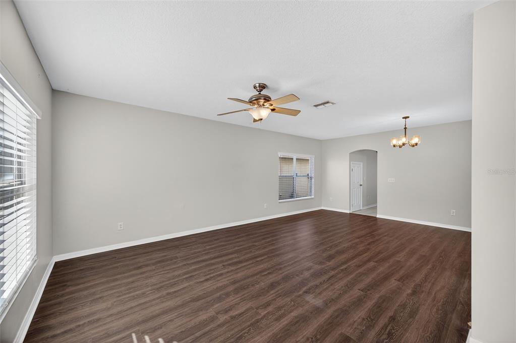 28632 Seashell Court Wesley Chapel, FL 33545 - Photo 15 of 60 a view of an empty room with wooden floor and a window